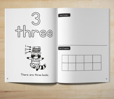 Photo of an open Count and Write number tracing activity book showing a coloring and counting page for the number 3